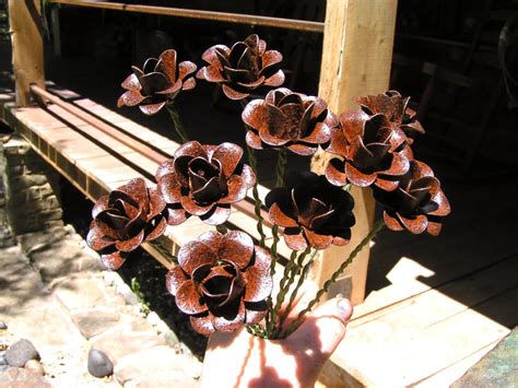 Ten SMALL metal Rust rose flowers WITH STEMS, accents